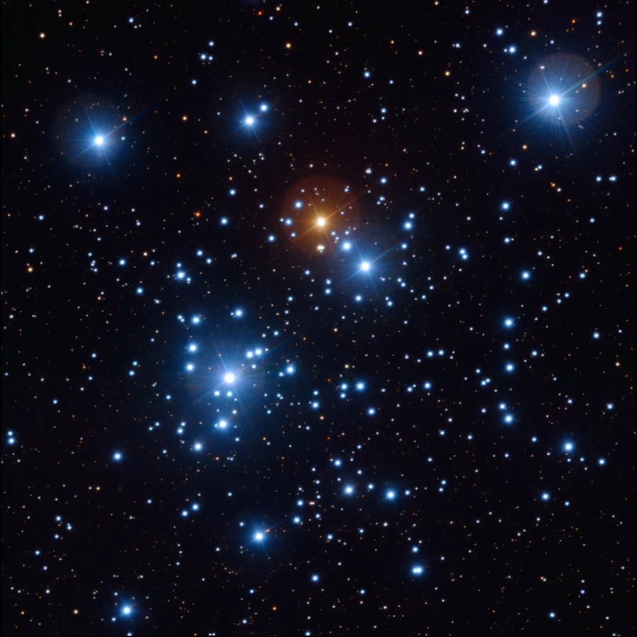 El cúmulo del Joyero: estrellas azules brillantes y una anaranjada en el centro, sobre un campo denso